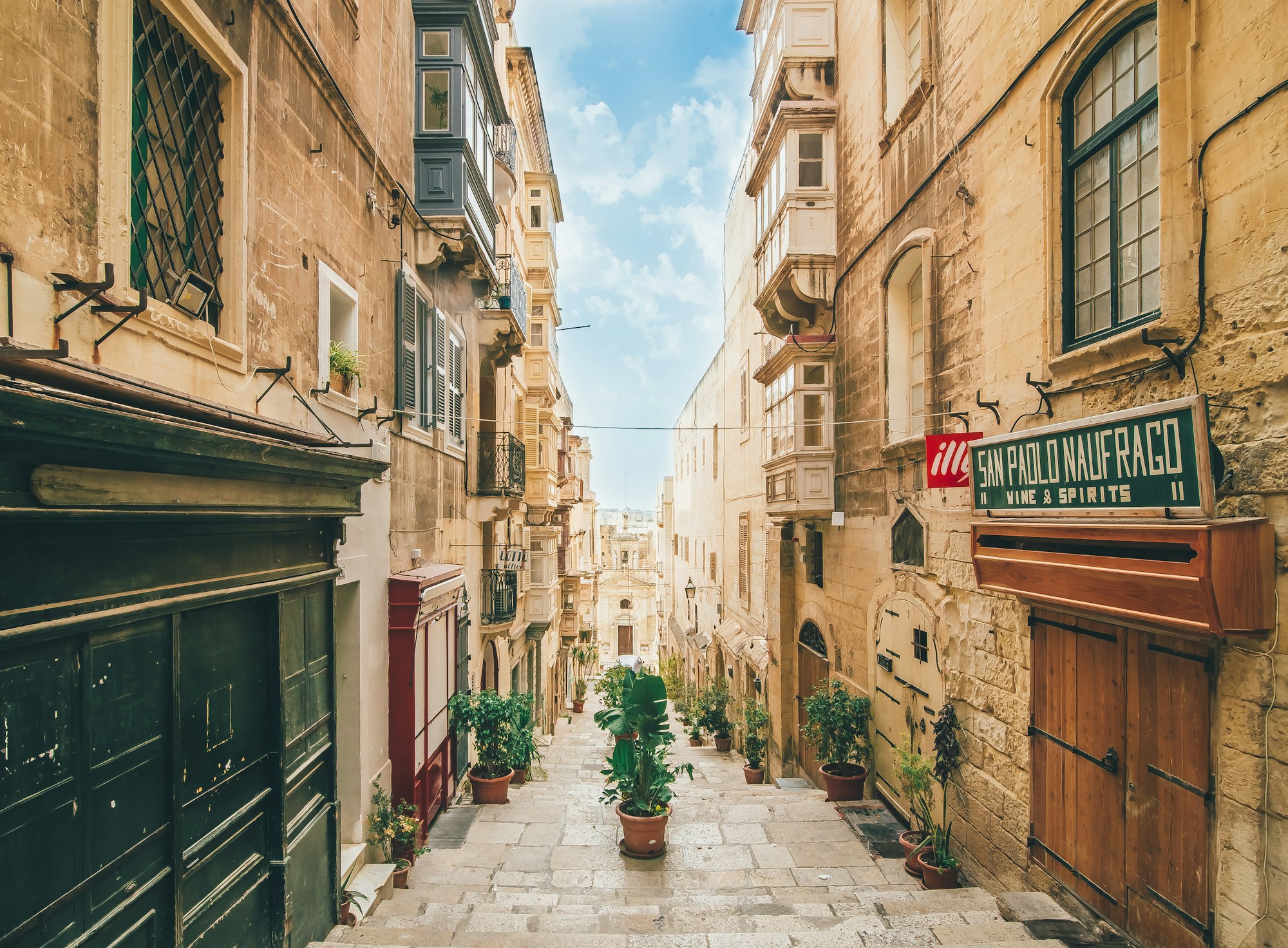 Quiet stepped street in Valletta with balconies