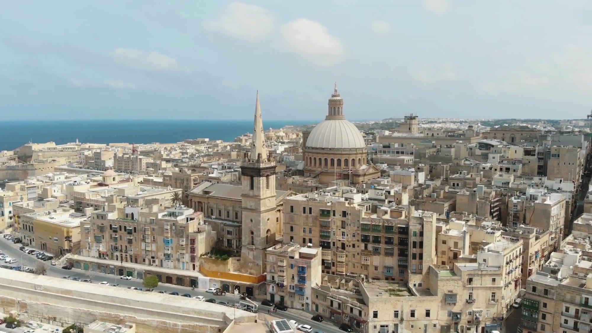 Valletta skyline with the Carmelite Church dome and St Paul's steeple over the city's limestone walls